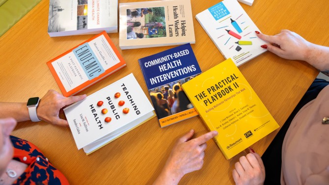 Meredith and colleagues sort through essential reading for the Public Health Essentials online program.