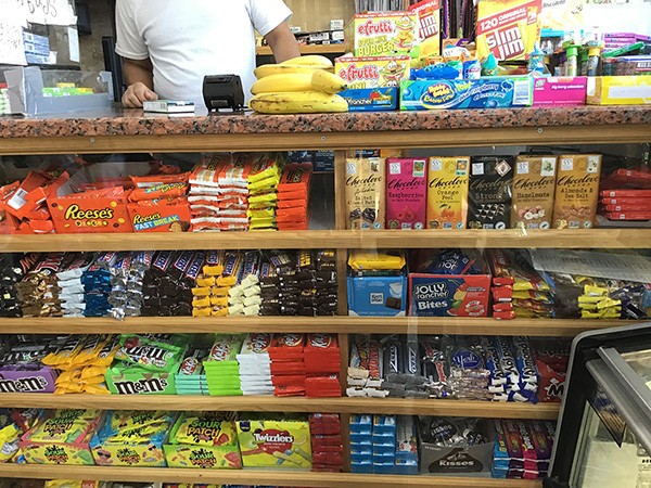 A few lone bananas can be found among a sea of candy near a cash register in a Harlem bodega. A youth participant captured the image as part of a photojournalism project, which the group used to create their bodega improvement plans.