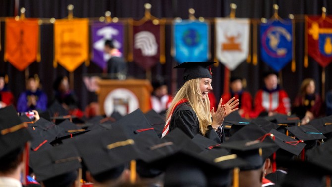 Graduate applauds during ceremony