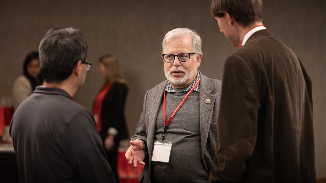 three men in conversation