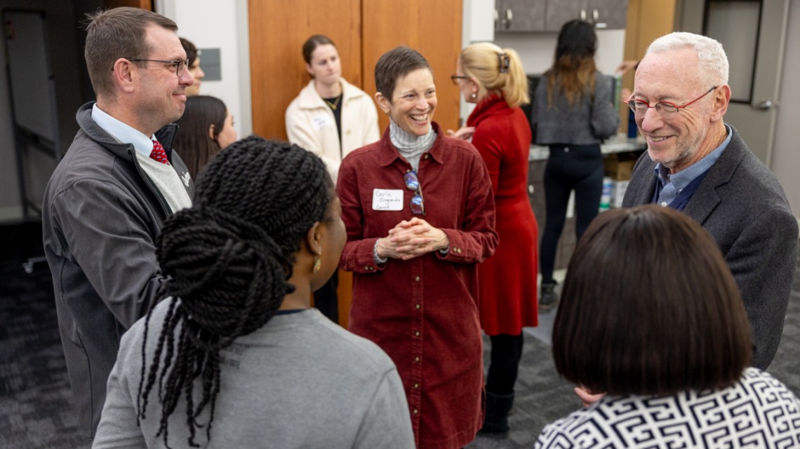 Interim President Michael Kotlikoff, right, and Carla Ingrando, center, who leads the Philanthropic Leadership class, speak with guests at the Dec. 3 ceremony honoring grant awardees.