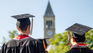 Capped graduates view McGraw tower.