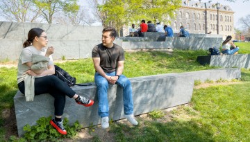 Students enjoy a warm spring day on the Sesquicentennial Grove.